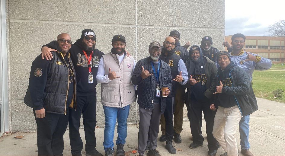  Picture of members of Alpha Phi Alpha in front of Emerson.